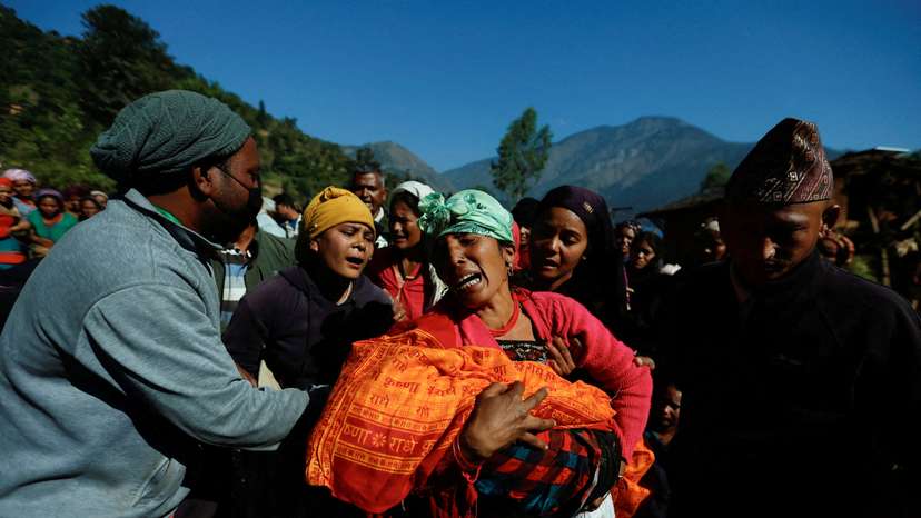 FILE PHOTO: A woman holding a child who died during an earthquake mourns in Jajarkot