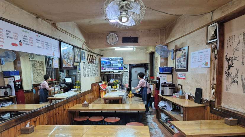 A restaurant owner waits for customers at her empty restaurant in Seoul