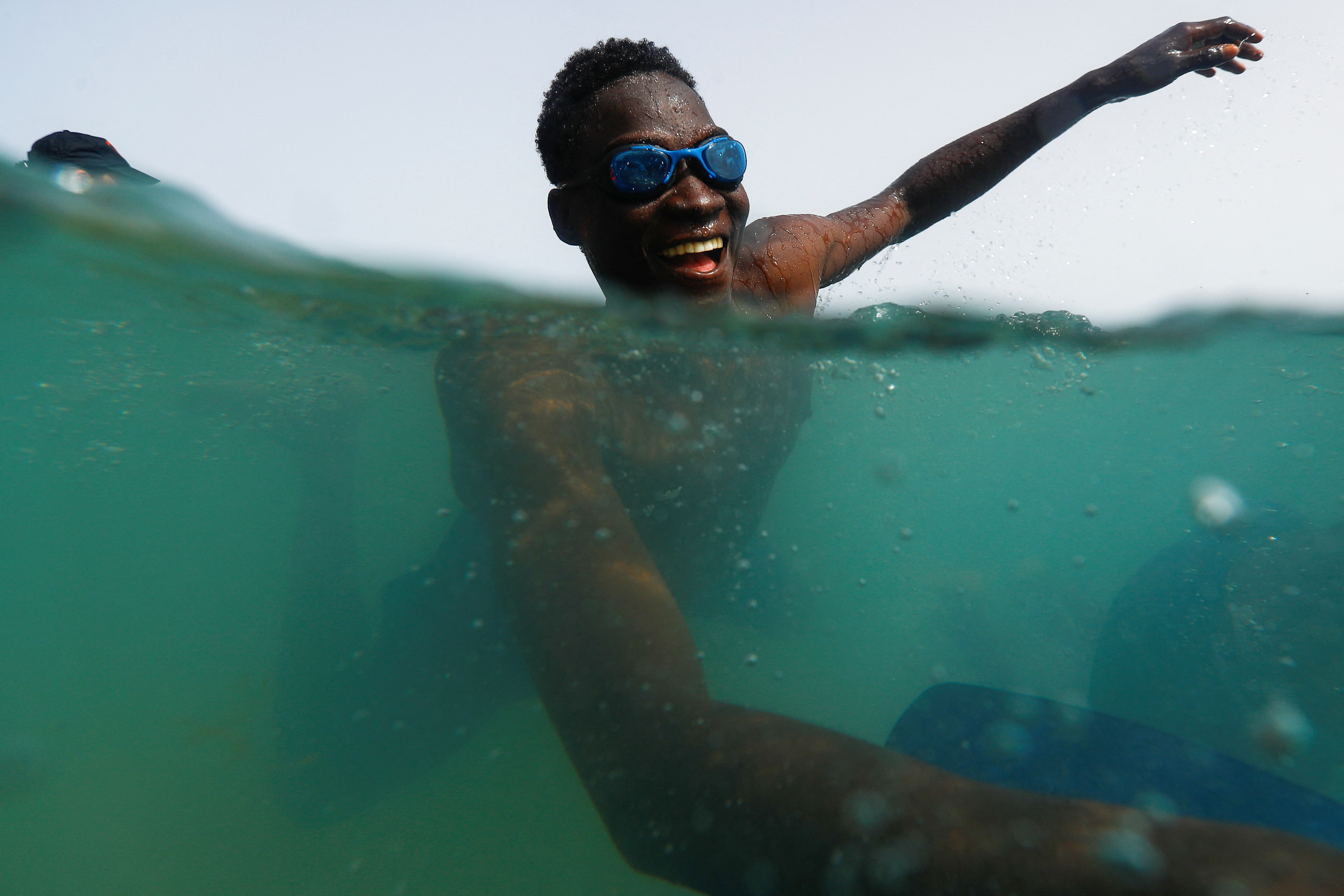 A migrant takes part in the activity organized by the NGO ProemAID's "Water Project" to overcome the traumatic experience of a dangerous sea crossing