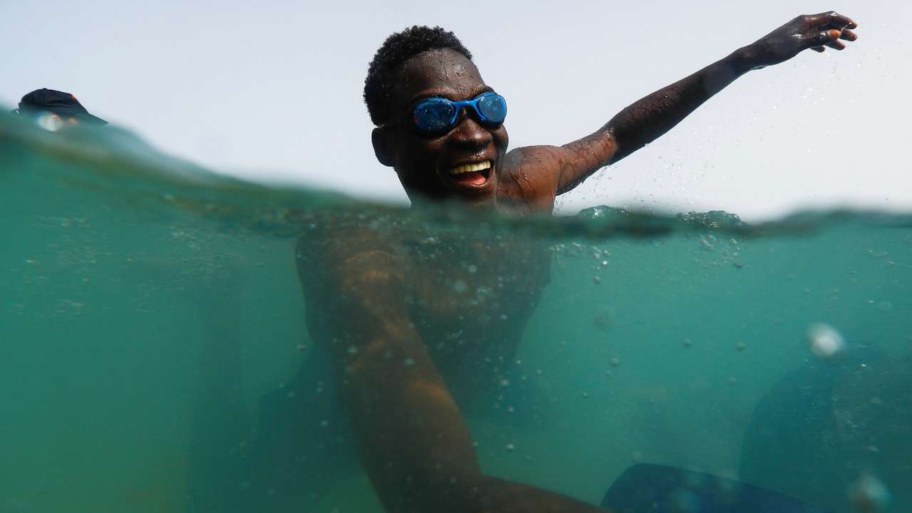 A migrant takes part in the activity organized by the NGO ProemAID's "Water Project" to overcome the traumatic experience of a dangerous sea crossing