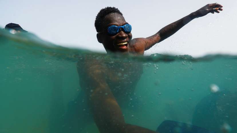 A migrant takes part in the activity organized by the NGO ProemAID's "Water Project" to overcome the traumatic experience of a dangerous sea crossing