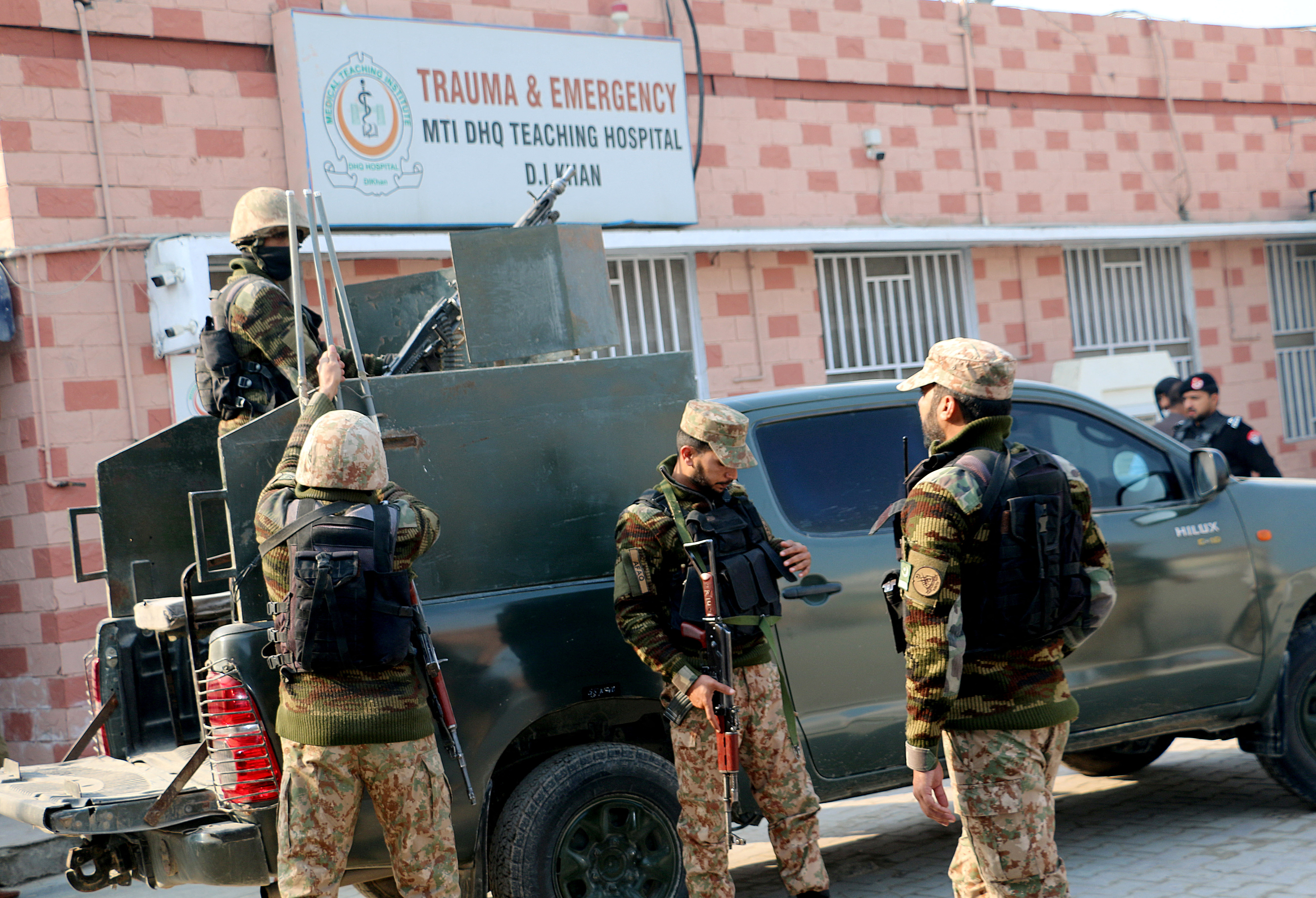 Security personnel stand guard outside a hospital, in Dera Ismail Khan