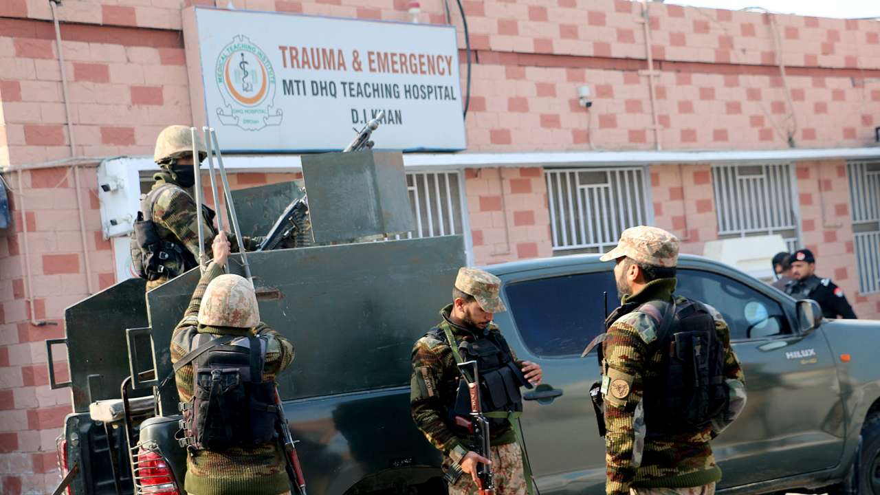 Security personnel stand guard outside a hospital, in Dera Ismail Khan