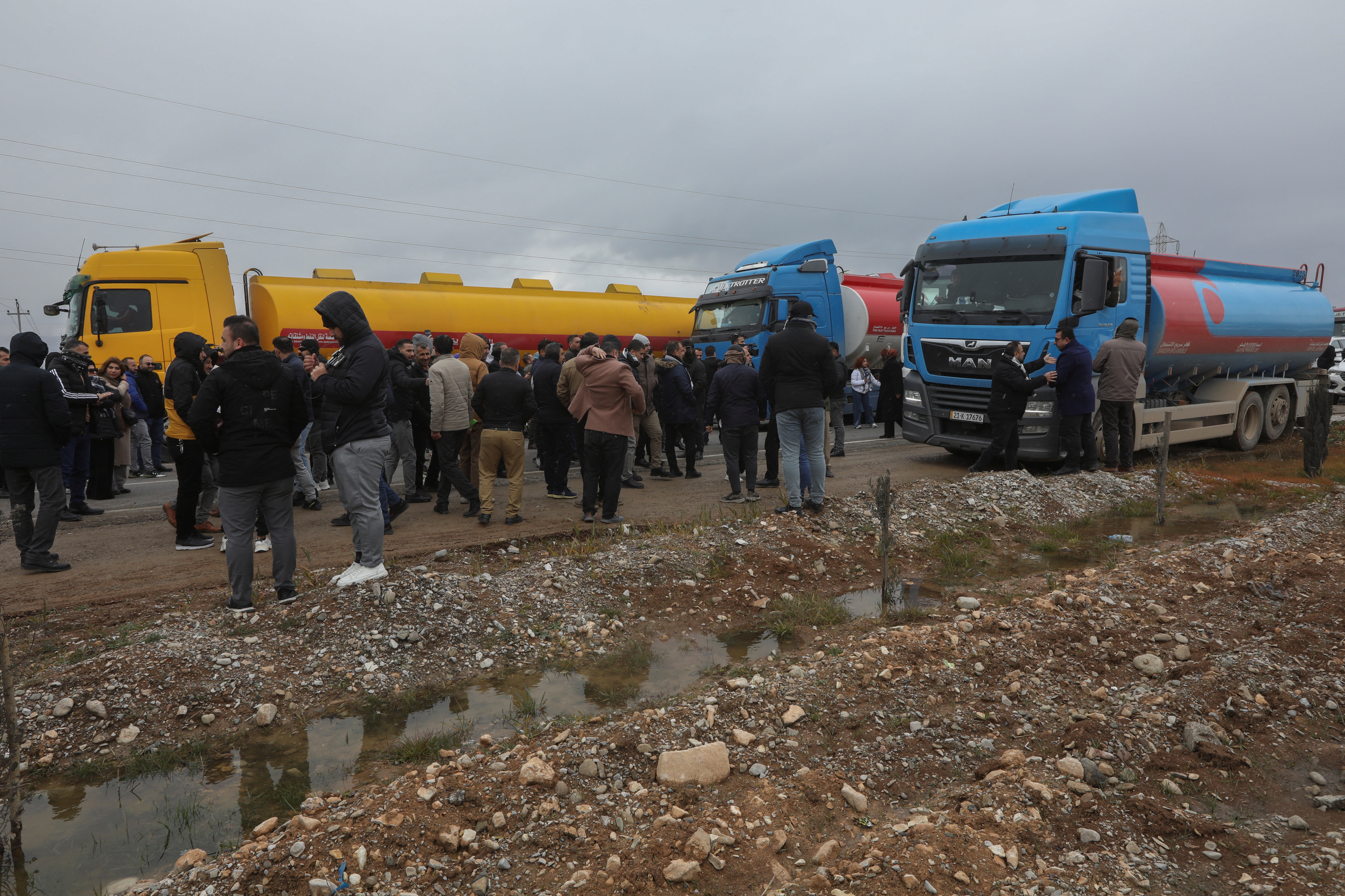 FILE PHOTO: Kurdish protesters block the road in front of trucks carrying oil in the Arbat area near Sulaymaniyah