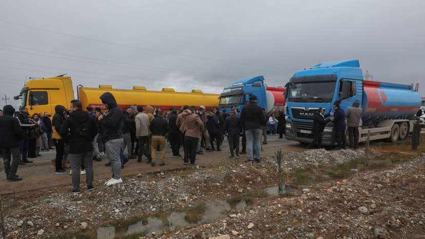 FILE PHOTO: Kurdish protesters block the road in front of trucks carrying oil in the Arbat area near Sulaymaniyah