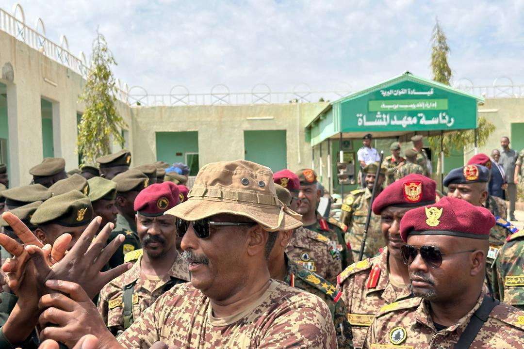 Head of Sudan's armed forces Abdel Fattah al-Burhan greets officers after drone strike hit army base, in Gebit