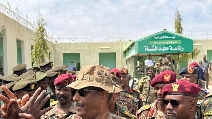 Head of Sudan's armed forces Abdel Fattah al-Burhan greets officers after drone strike hit army base, in Gebit