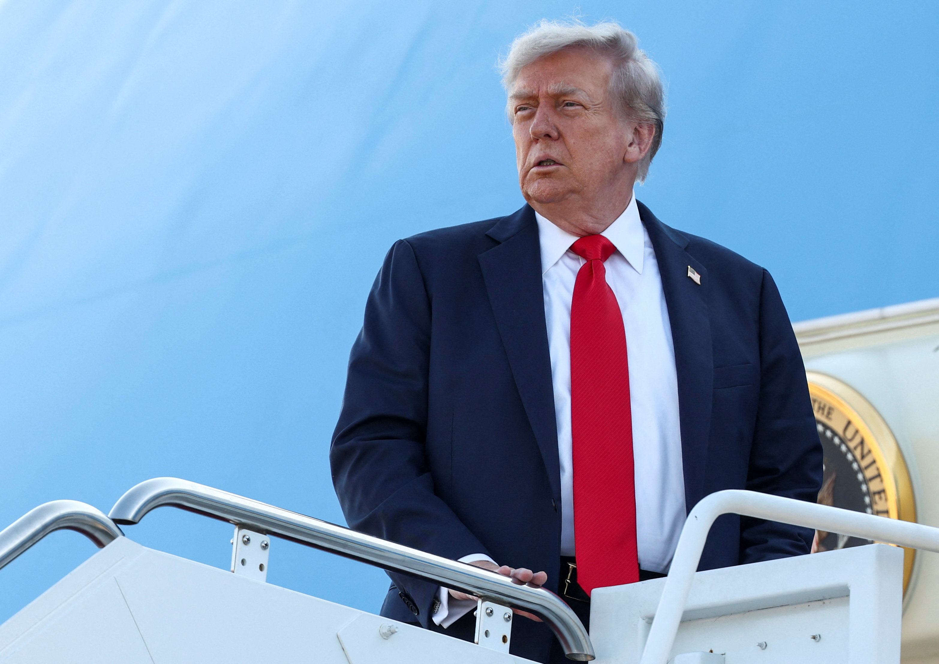U.S. President Trump boards Air Force One as he departs for Alaska to meet with Russian President Putin