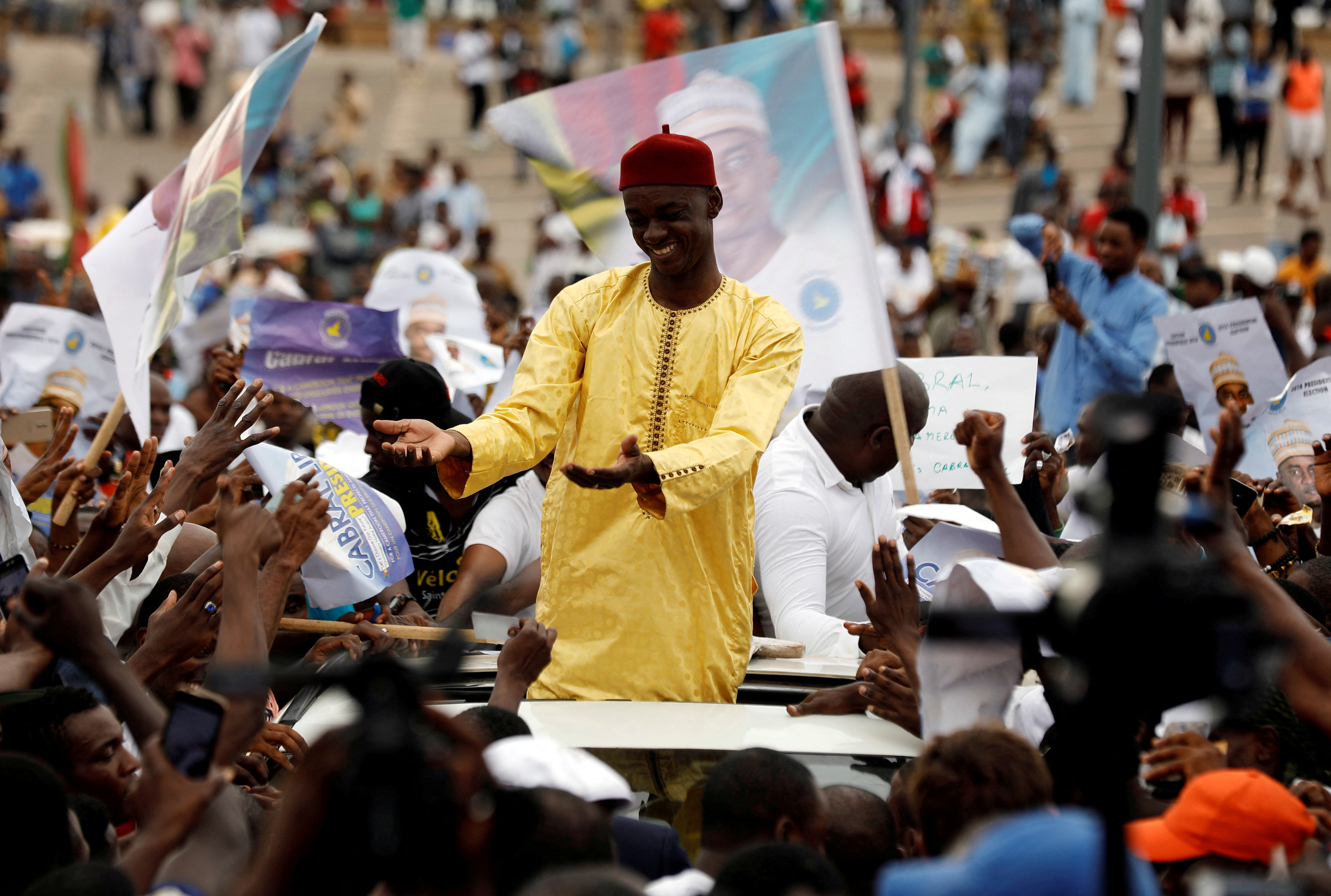 FILE PHOTO: Presidential candidate Cabral Libii of Univers party greets supporters as he arrives for his final campaign rally in Yaounde
