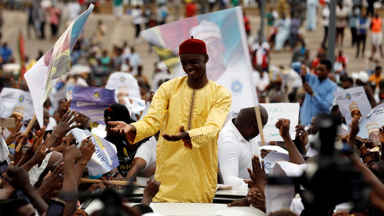 FILE PHOTO: Presidential candidate Cabral Libii of Univers party greets supporters as he arrives for his final campaign rally in Yaounde