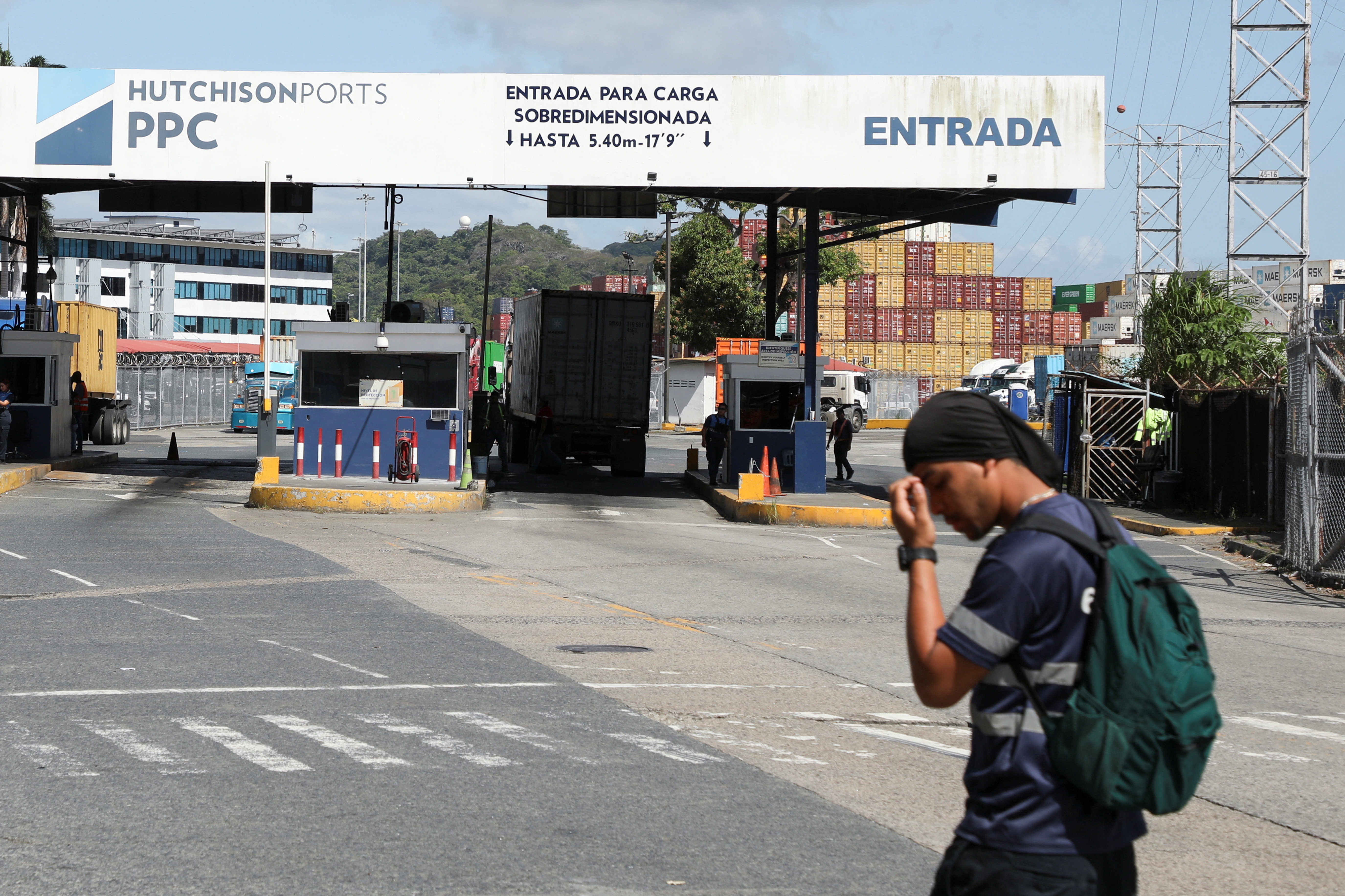 A worker walks past the port gate of Panama Ports Company (PPC), after Panama's Supreme Court annulled key port contracts held by the Hong Kong‑based CK Hutchison–owned firm, leaving the future of some Panama Canal operations uncertain, in Panama City, Panama, January 30, 2026. REUTERS/Aris Martinez