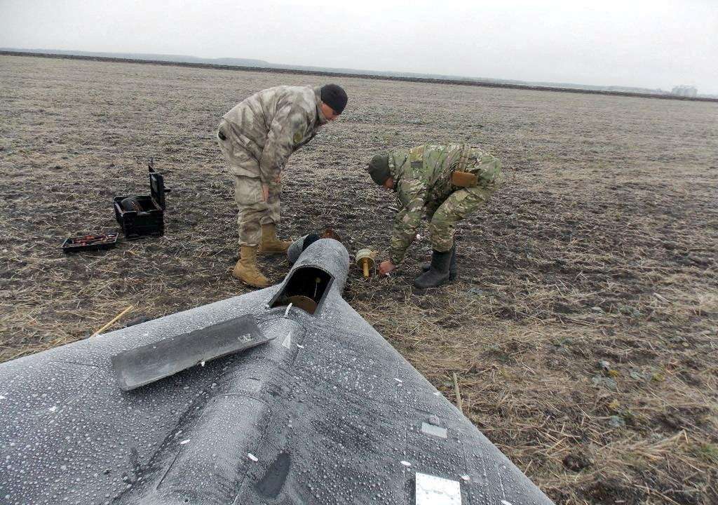 FILE PHOTO: Members of police demining unit remove a warhead from a Russian kamikaze unmanned aerial vehicle landed by a radio electronic warfare during one of latest drone strikes in an unknown location in Ukraine