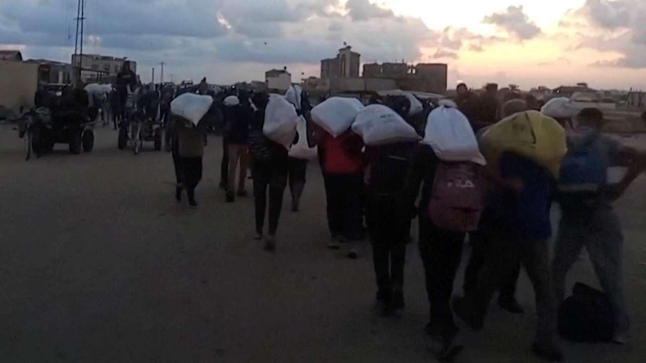 Palestinians carry aid supplies received from the U.S.-backed Gaza Humanitarian Foundation, in Rafah