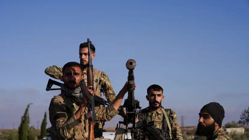 Members of Syrian security forces ride on a back of a truck after Syrian troops entered the predominantly Druze city of Sweida