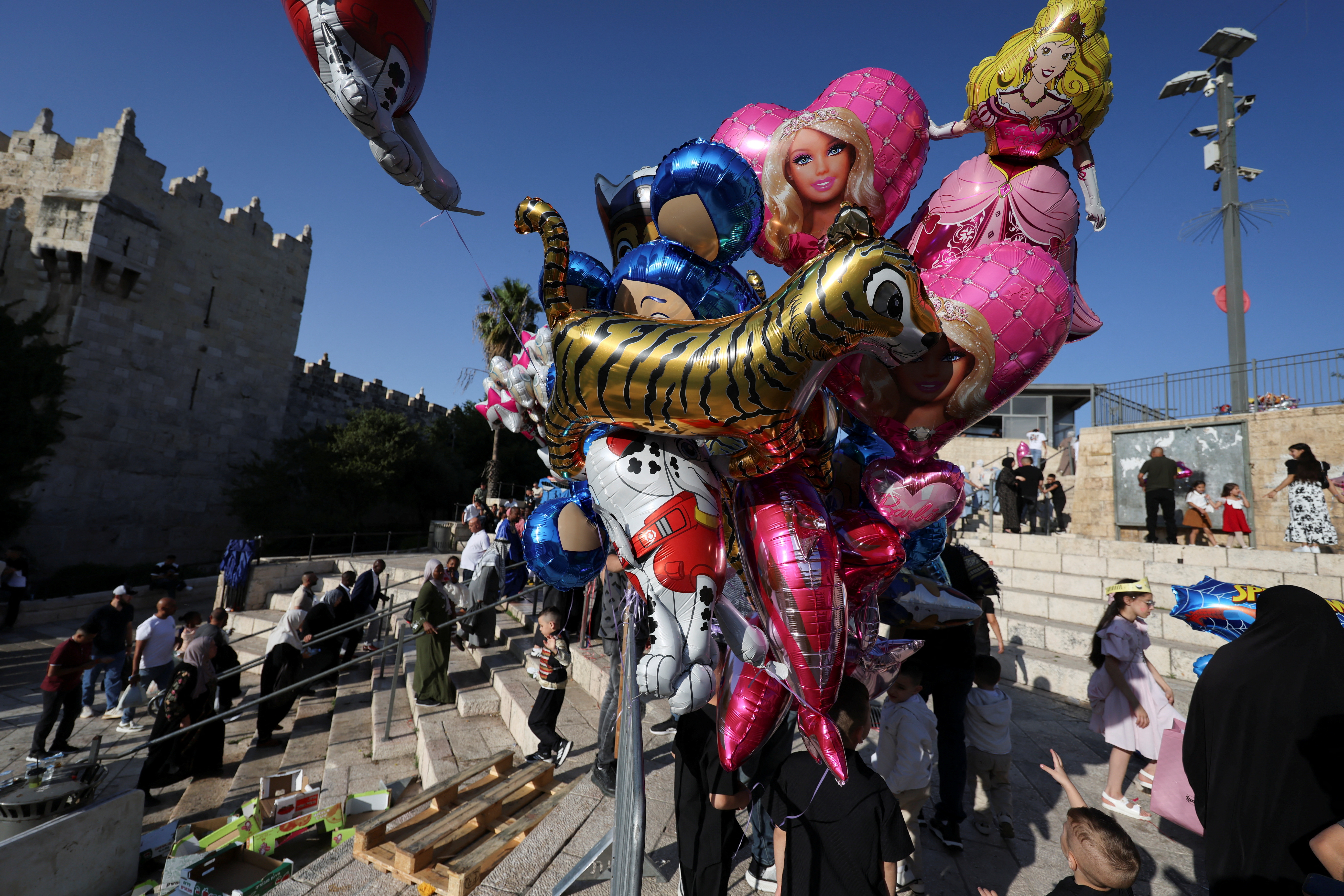 People gather near the Damascus gate on the first day of the Muslim holiday of Eid al-Adha, in Jerusalem's Old City