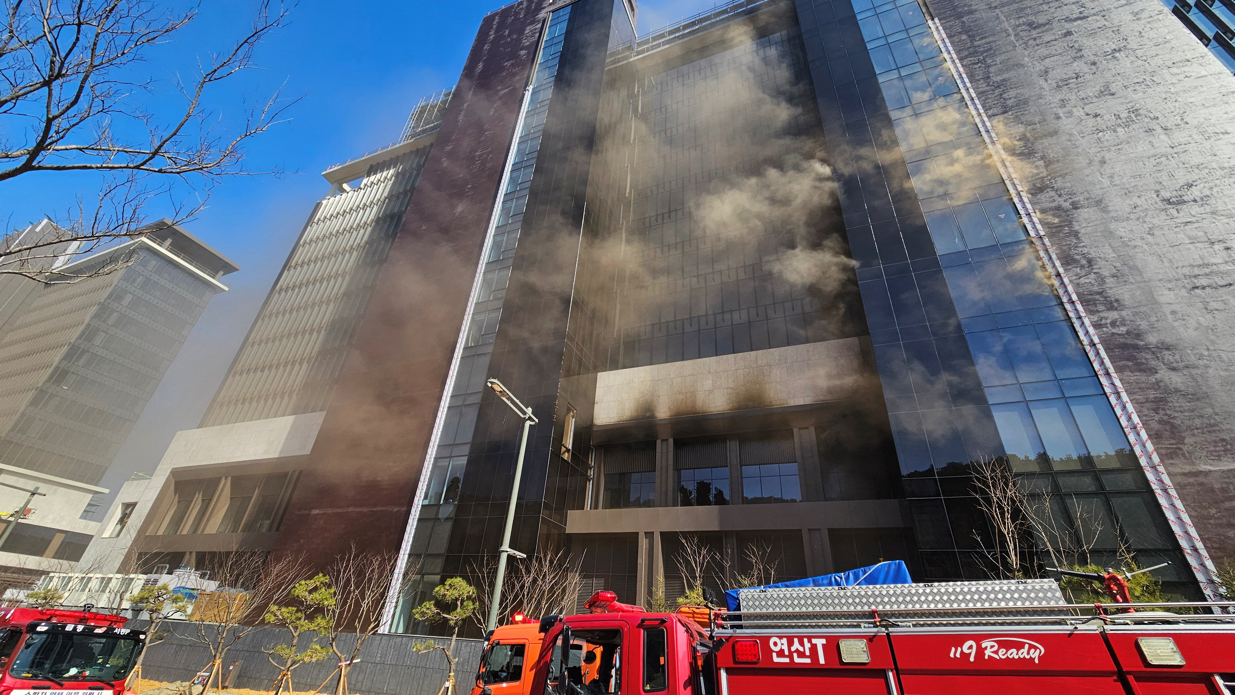 Smoke rises from a building which is currently under construction in Busan