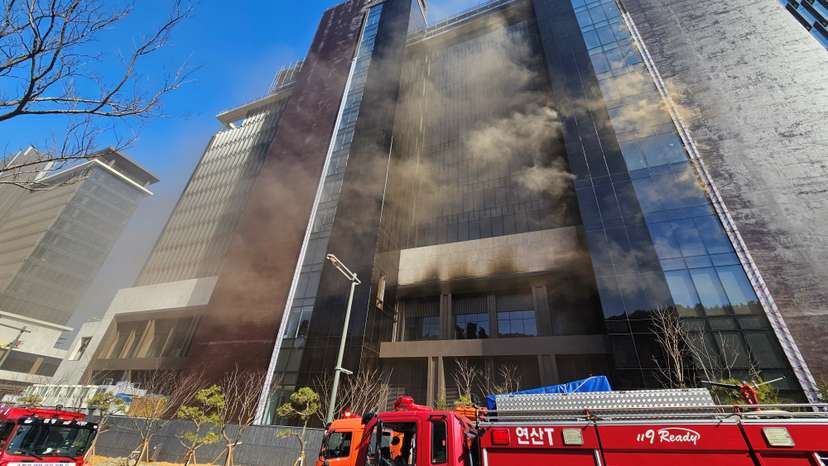 Smoke rises from a building which is currently under construction in Busan