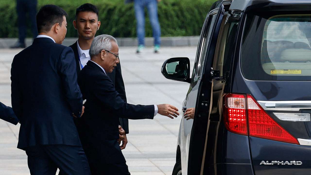 Former president of Macau's Court of Final Appeal, Sam Hou-fai, walks towards a vehicle after a press conference to announce his candidacy for Macau's sixth-term Chief Executive election, in Macau