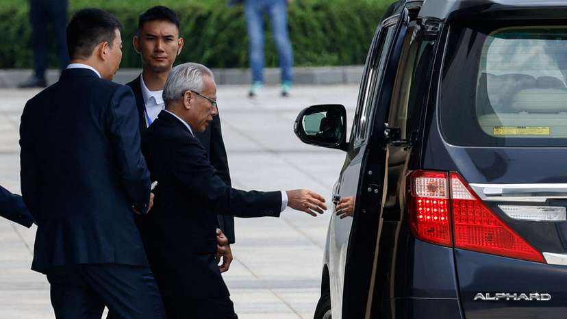 Former president of Macau's Court of Final Appeal, Sam Hou-fai, walks towards a vehicle after a press conference to announce his candidacy for Macau's sixth-term Chief Executive election, in Macau
