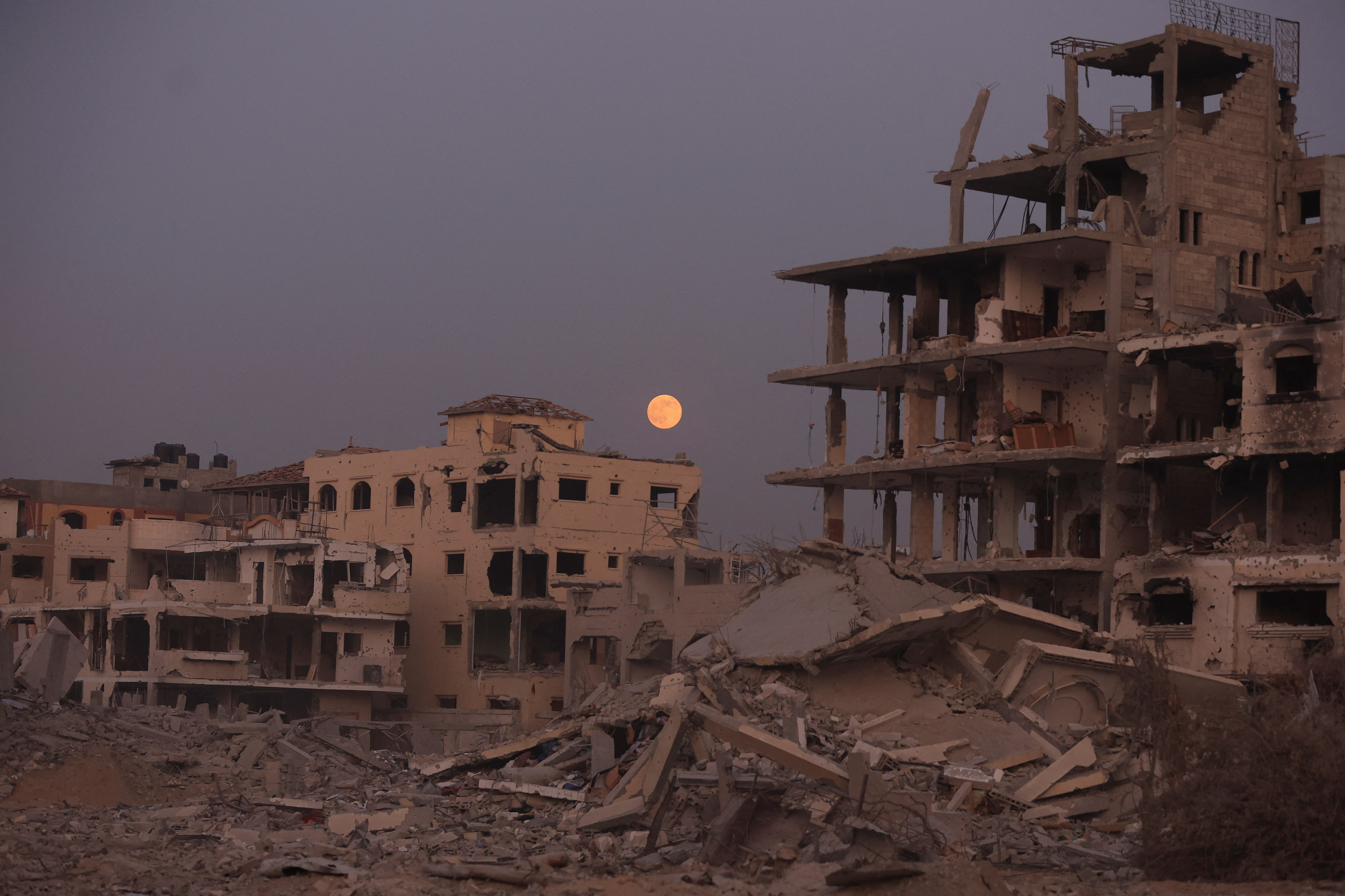 The Beaver Moon supermoon rises above destroyed buildings amid a ceasefire between Israel and Hamas, in Gaza City