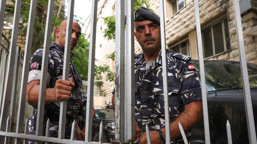 Lebanese police officers lock one of the doors of the Justice Palace in Beirut
