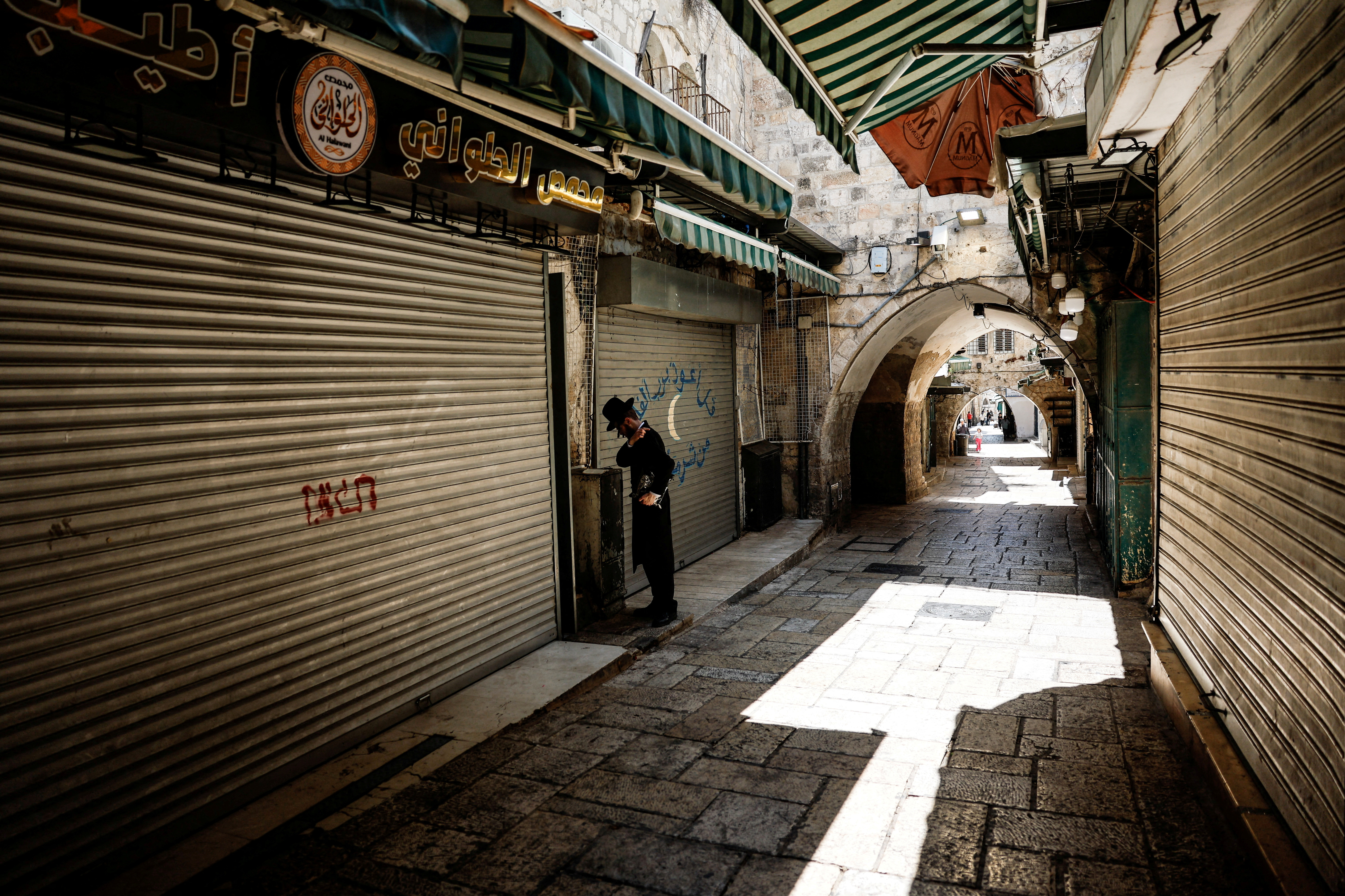 FILE PHOTO: An Untra Orthodox Jewish man pauses in an alley in Jerusalem's Old City, as shops are closed, following an overnight Israeli attack on Iran, as part of the readiness for retaliation, in Jerusalem