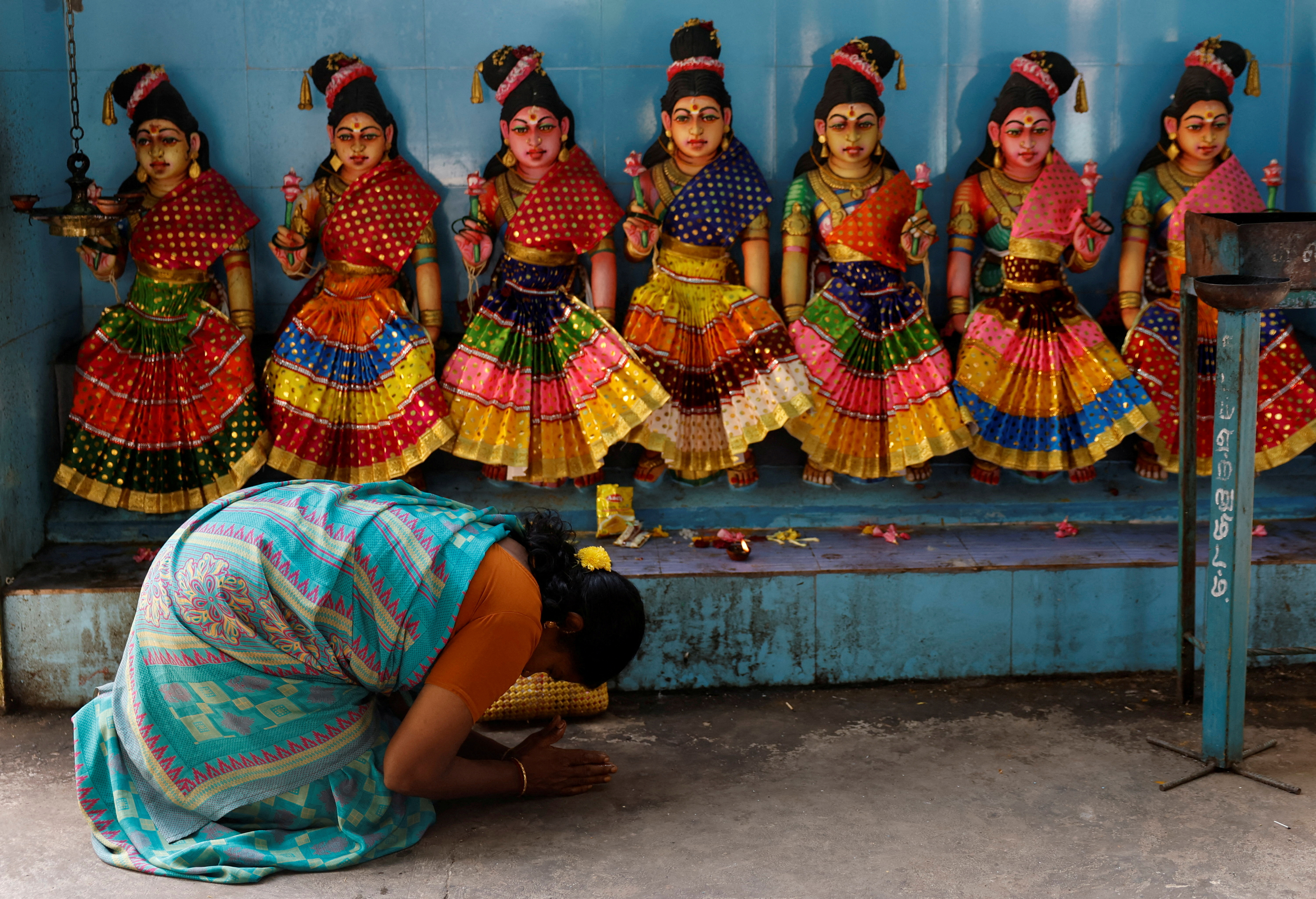 A devotee prays inside the Sri Dharmasastha temple in Thulasendrapuram