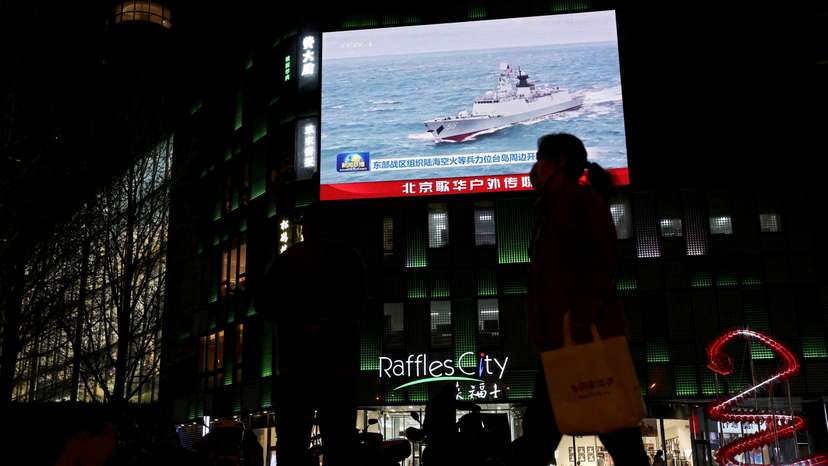 FILE PHOTO: News footage on China's military drills, in Beijing