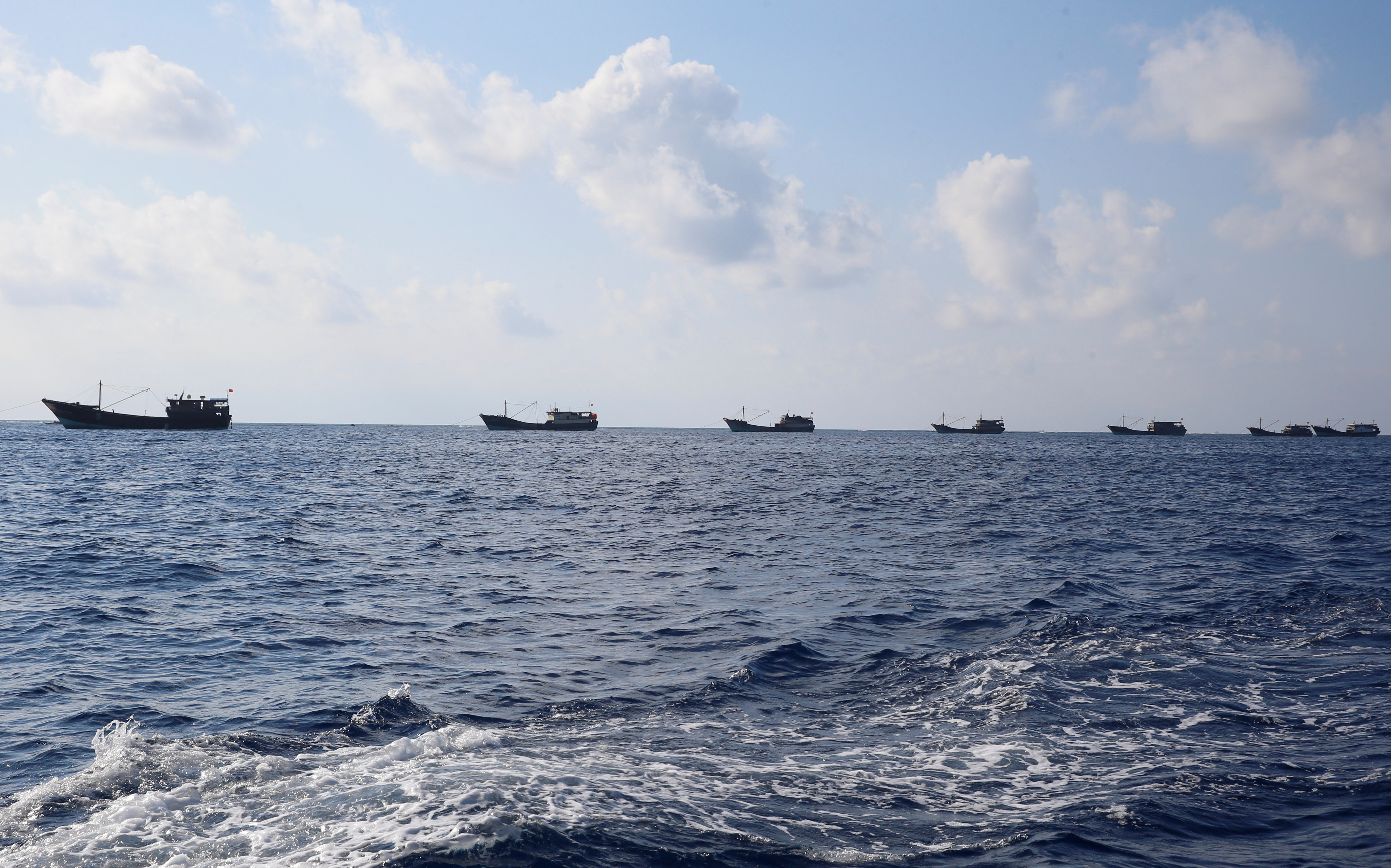 Chinese boats fish at the disputed Scarborough Shoal