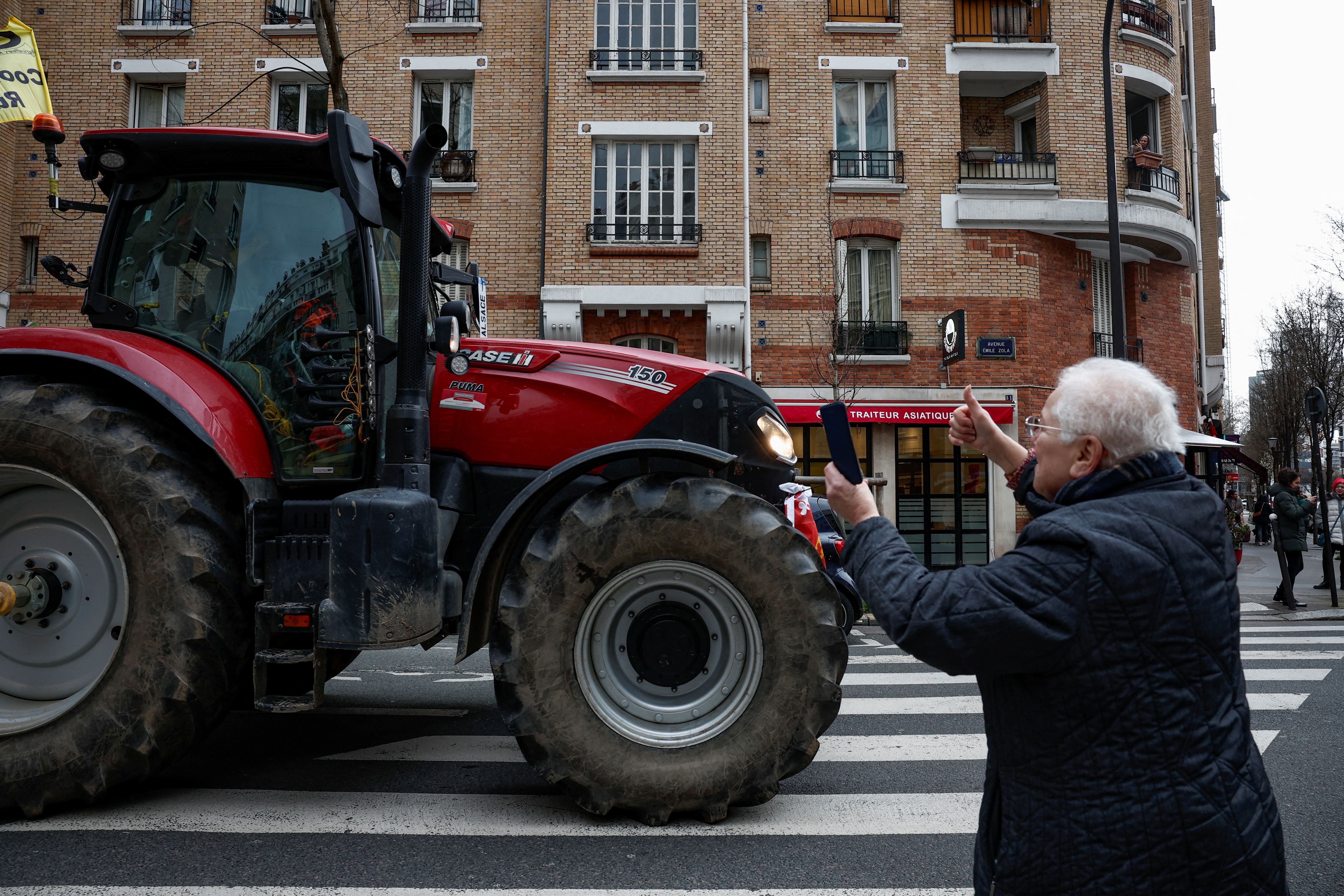 Farmers protest on the evening of the Paris farm show, in Paris