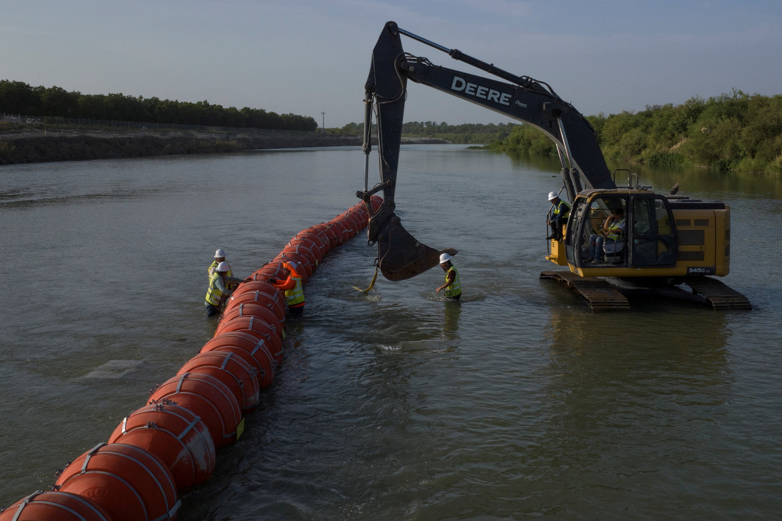 FILE PHOTO: Workers assemble buoys at U.S. Mexico border in Eagle Pass, Texas
