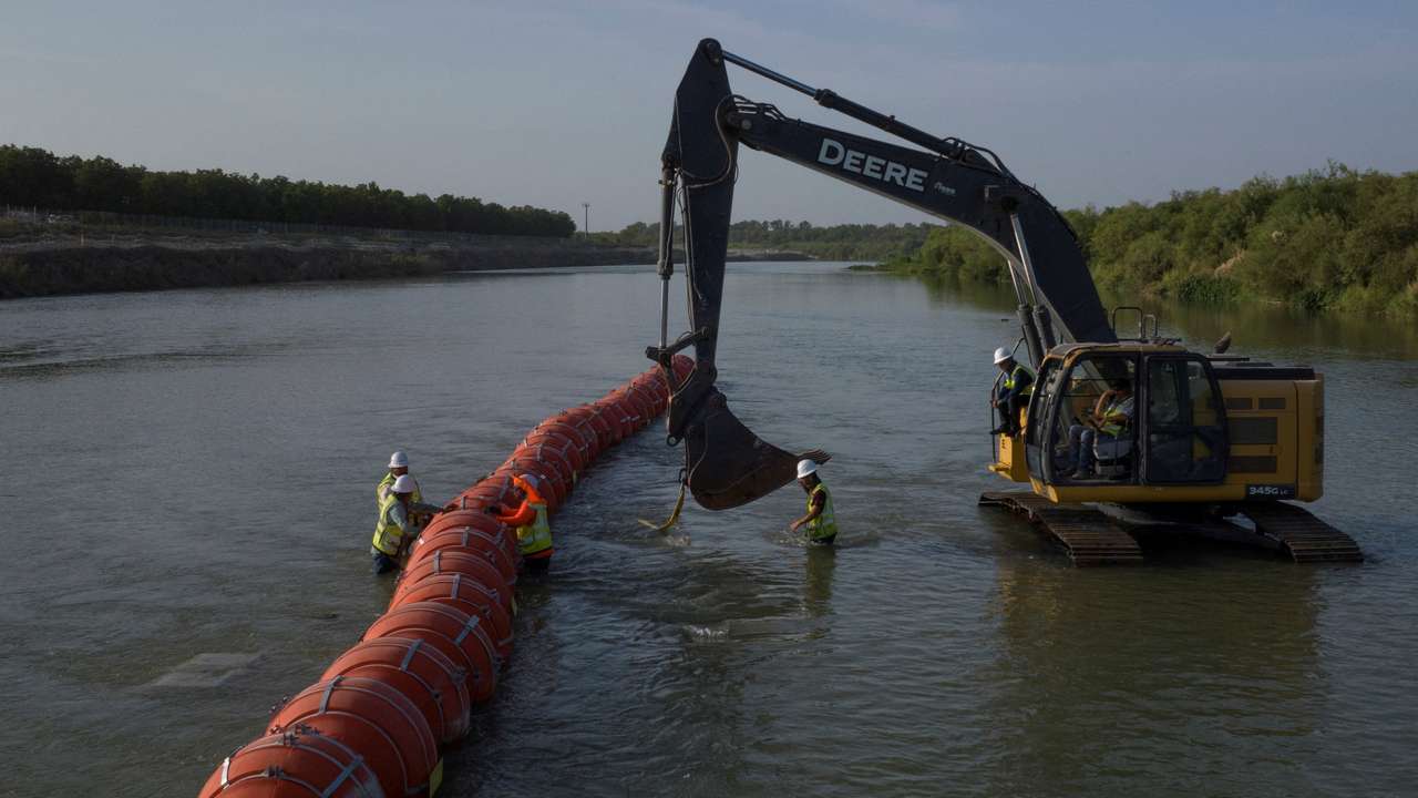 FILE PHOTO: Workers assemble buoys at U.S. Mexico border in Eagle Pass, Texas