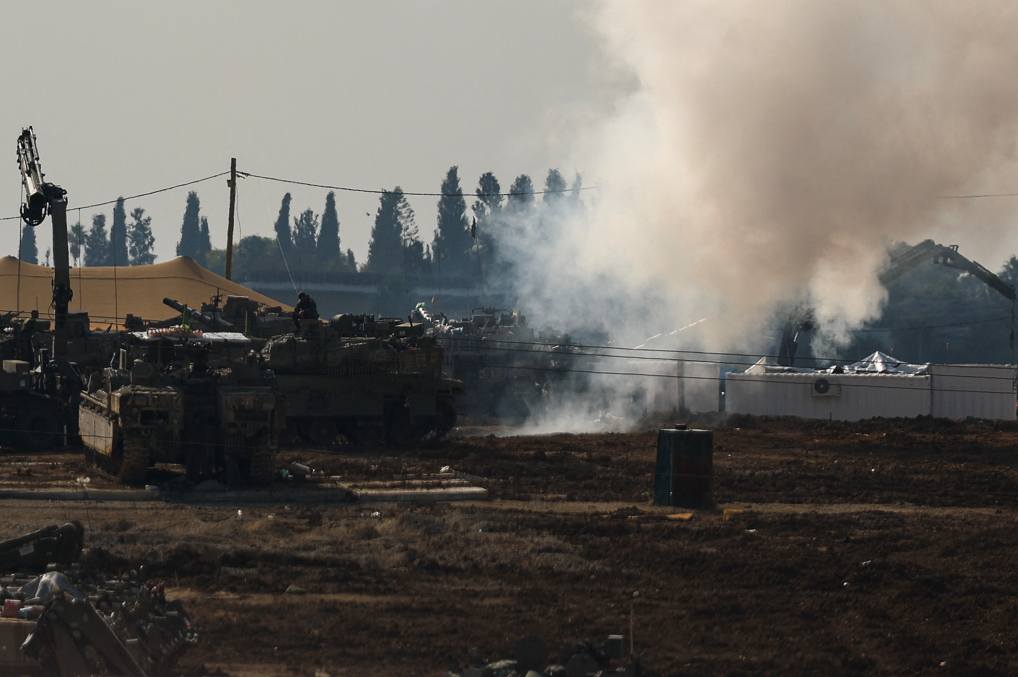 Israeli military vehicles operate, near the Israel-Gaza border, in Israel