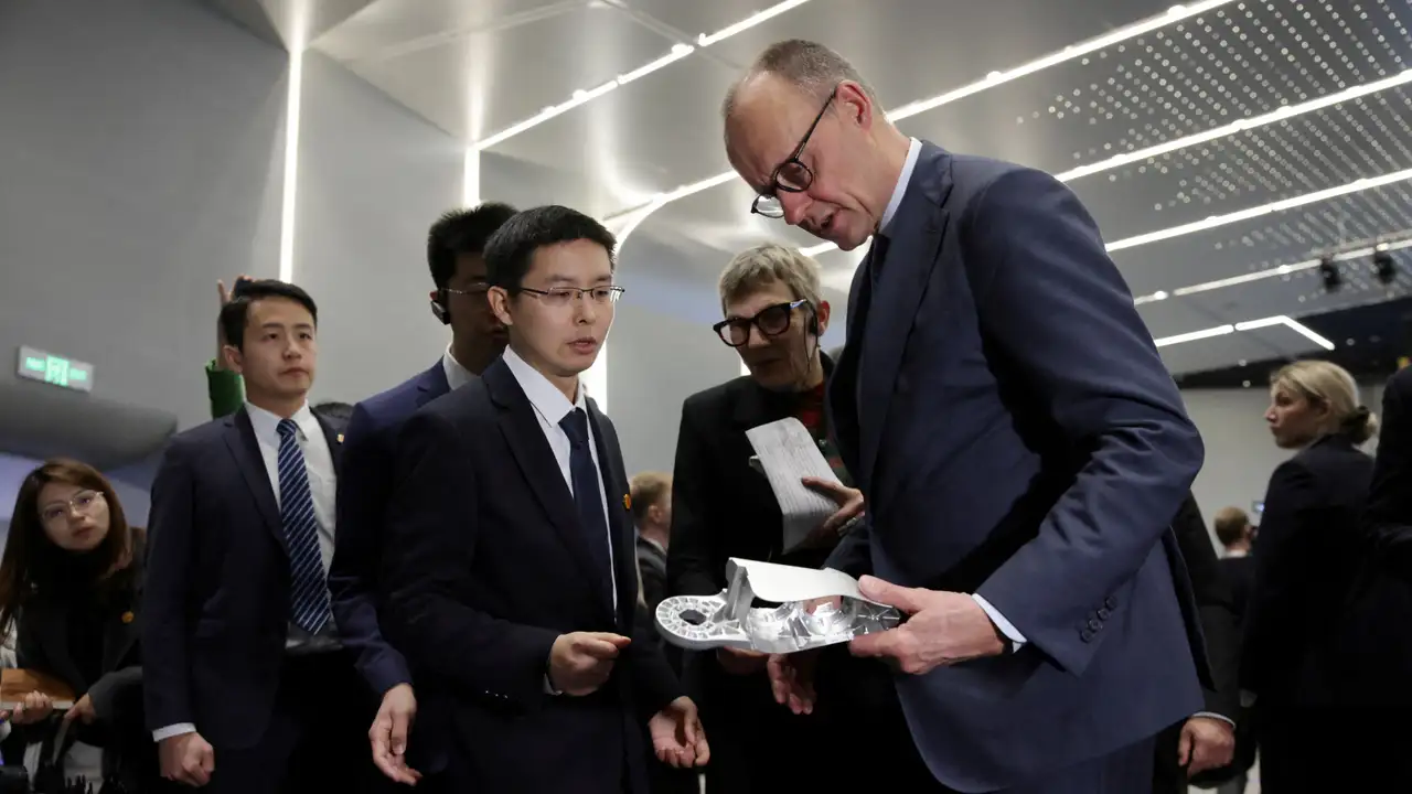 German Chancellor Friedrich Merz listens to Unitree Robotics CEO Wang Xingxing in Hangzhou, China