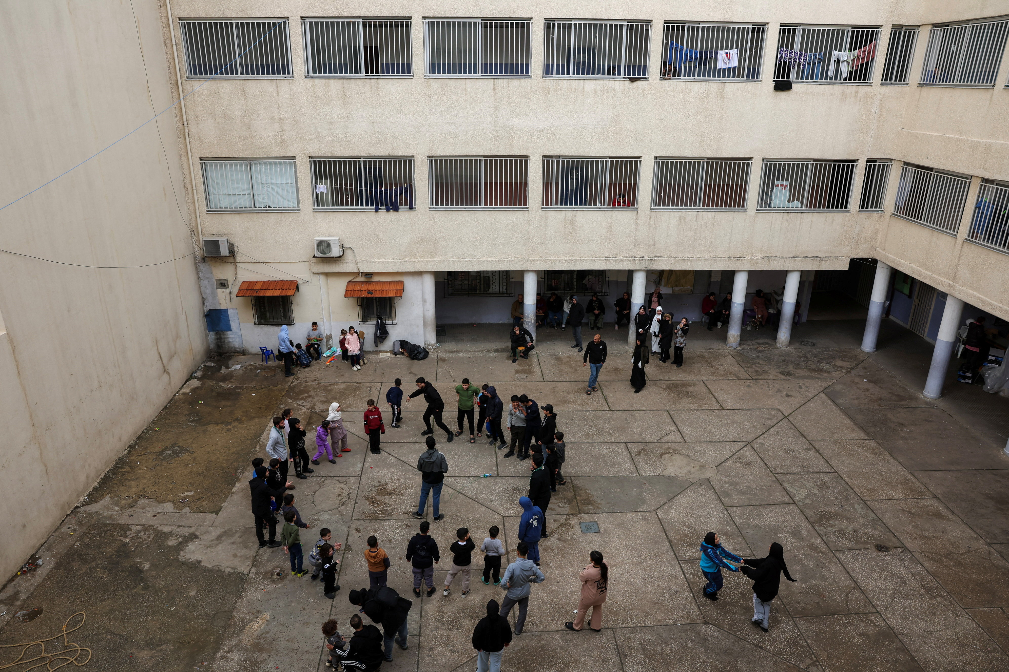 Children play at the yard of a school used as a temporary shelter for displaced people, following an escalation between Hezbollah and Israel, amid the U.S.-Israeli conflict with Iran, in Beirut