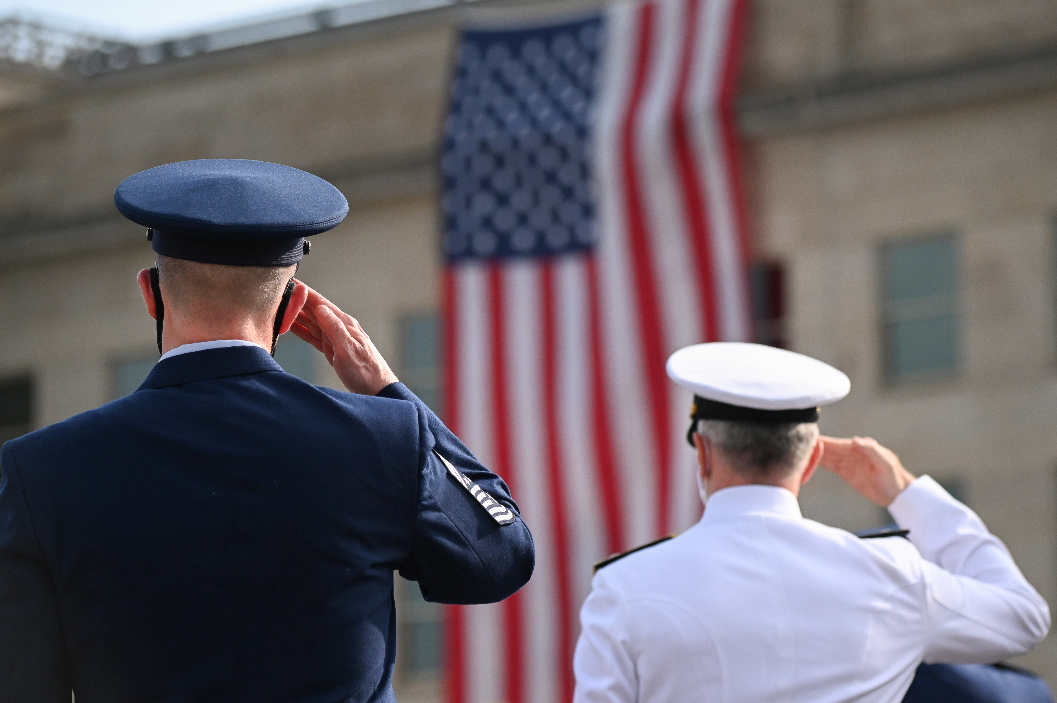 Members of the military salute during the 19th annual September 11 observance ceremony at the Pentagon