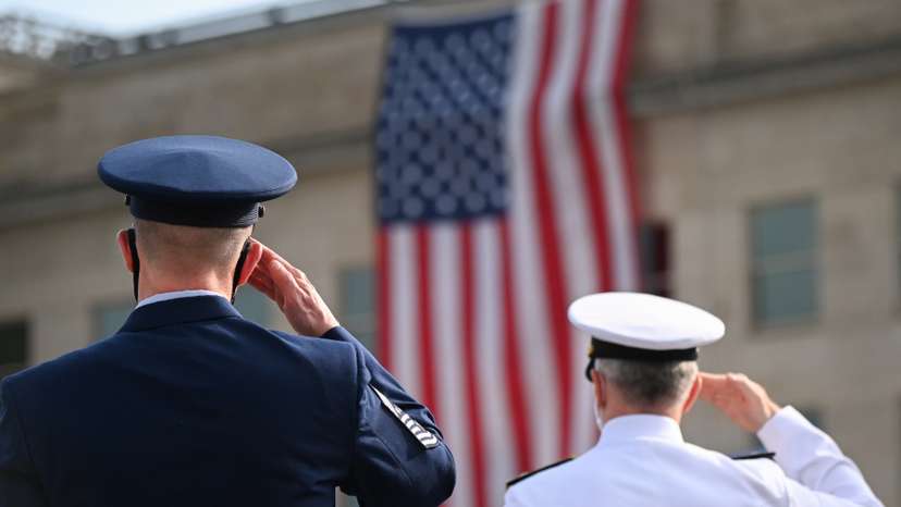Members of the military salute during the 19th annual September 11 observance ceremony at the Pentagon