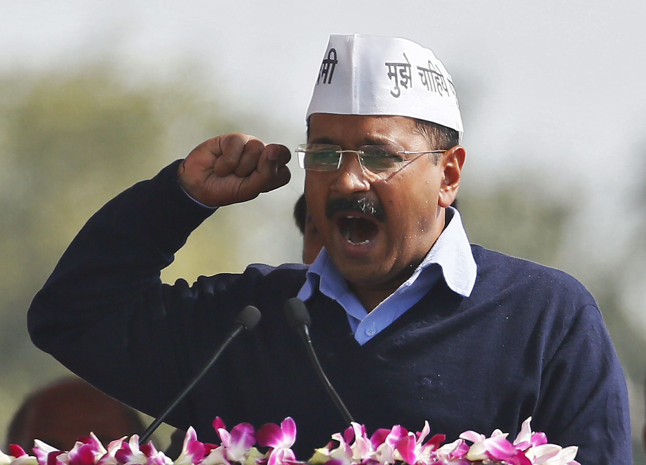FILE PHOTO: Kejriwal, chief of AAP, addresses his supporters after taking the oath as the new chief minister of Delhi during a swearing-in ceremony at Ramlila ground in New Delhi