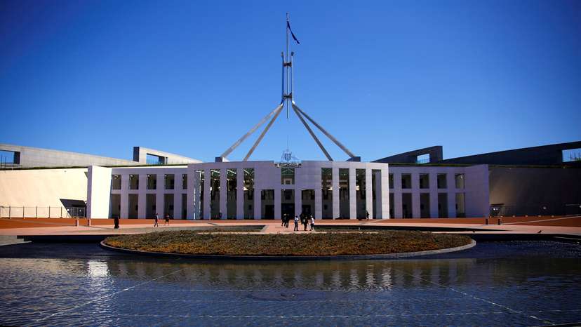 Tourists walk around the forecourt of Australia's Parliament House in Canberra