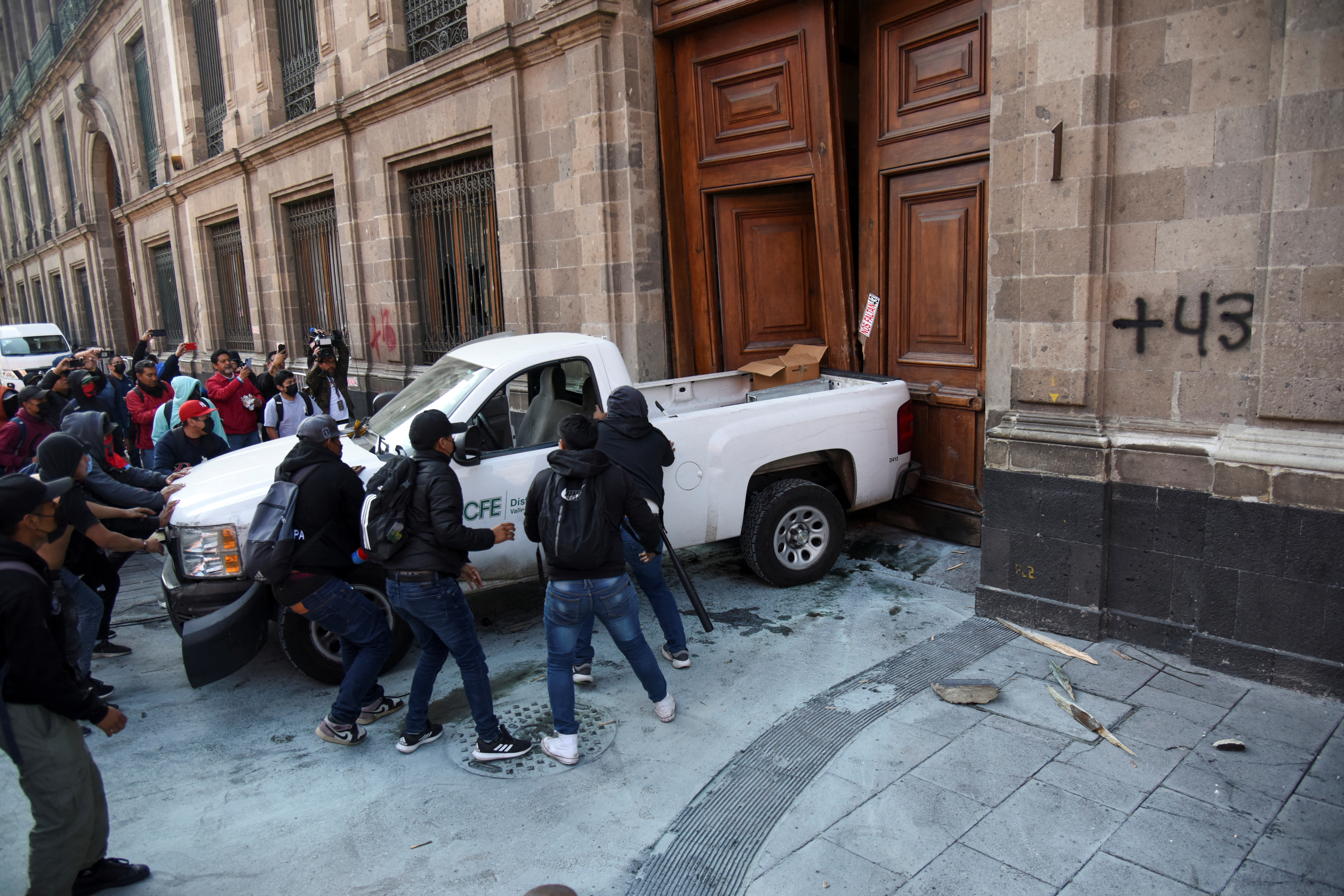 Group protesting over the disappearance of 43 students from Ayotzinapa in 2014 tries to force their way into the National Palace, in Mexico City