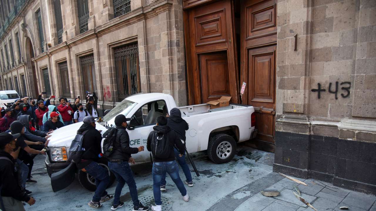 Group protesting over the disappearance of 43 students from Ayotzinapa in 2014 tries to force their way into the National Palace, in Mexico City