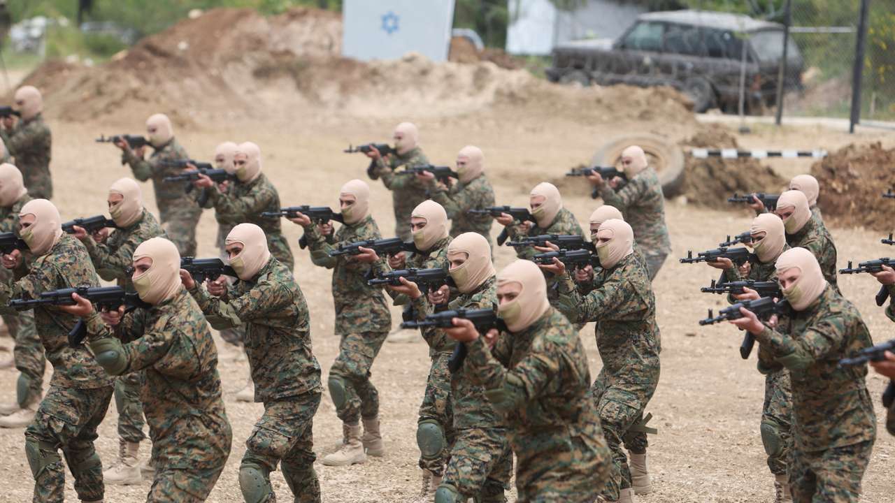 Hezbollah members take part in a military exercise during a media tour organized for the occasion of Resistance and Liberation Day, in Aaramta