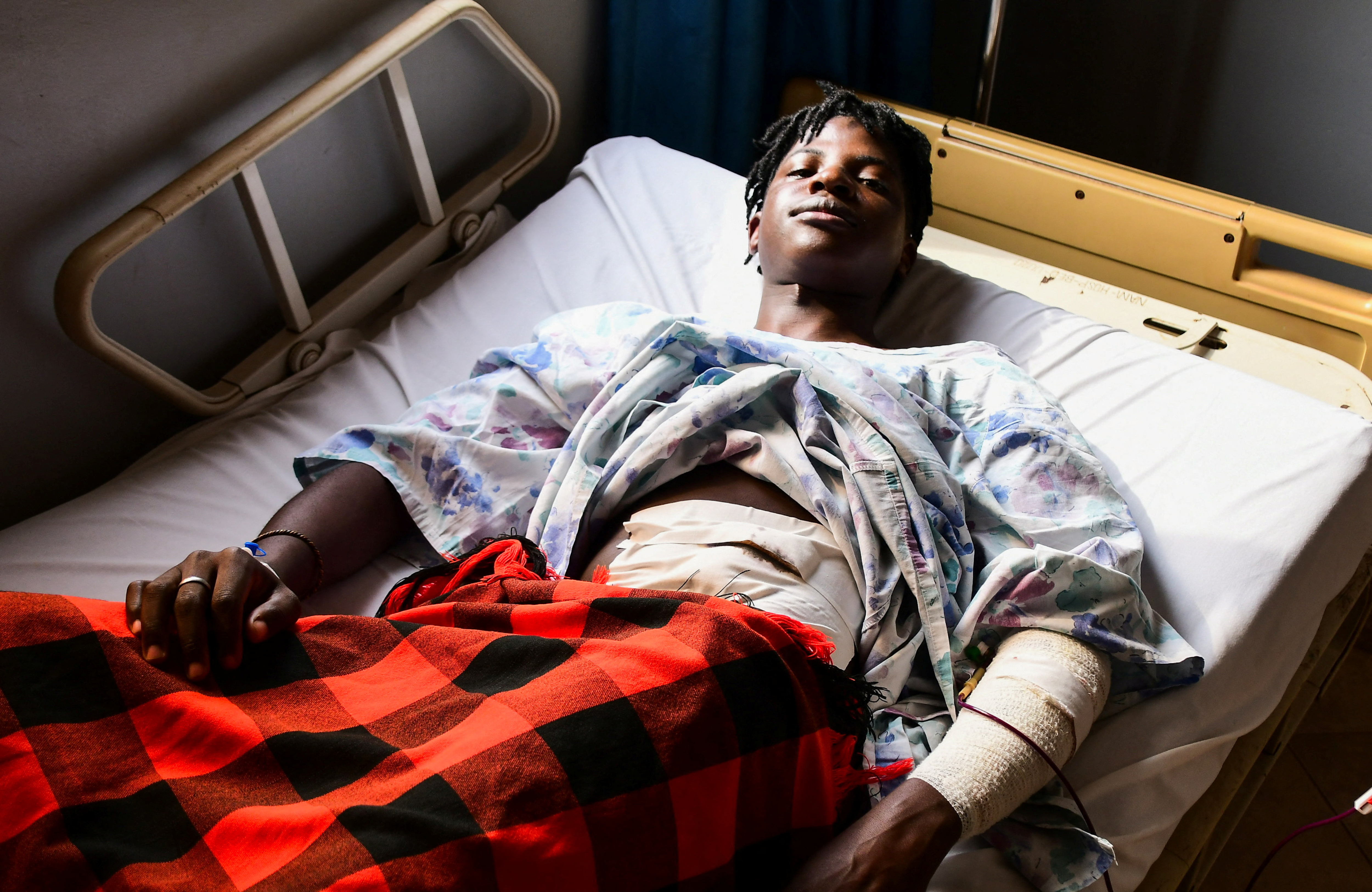 Ugandan LGBTQ activist Steven Kabuye receives treatment after he was stabbed by unknown people, at a hospital in Kitende along Entebbe road on the outskirts of Kampala