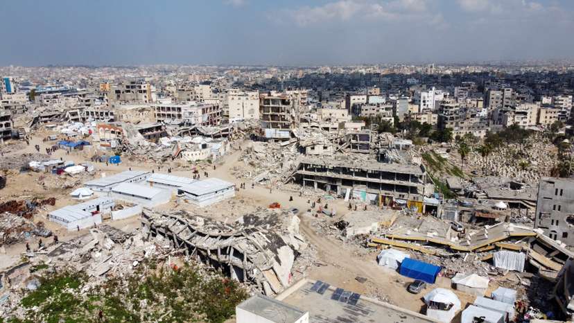 A drone view shows displaced Palestinians sheltering in tents set up near the rubble of buildings destroyed during the Israeli offensive, amid a ceasefire between Israel and Hamas, in Gaza City