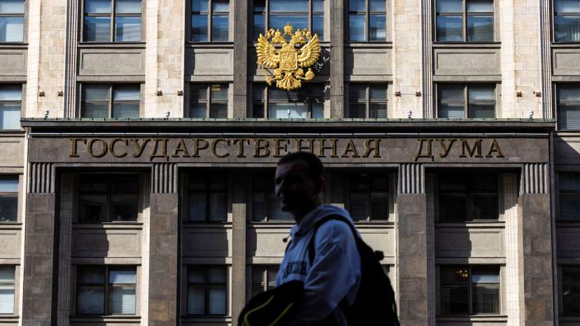 A man passes by the State Duma building, the lower chamber of Russian parliament in Moscow