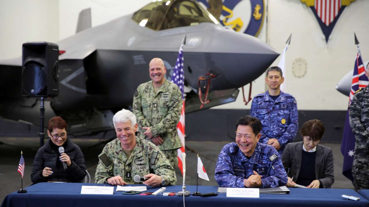 United States Seventh Fleet Vice Admiral and Japan Maritime Self-Defence Force Vice Admiral react during a press conference aboard USS Carl Vinson, in the Pacific Ocean