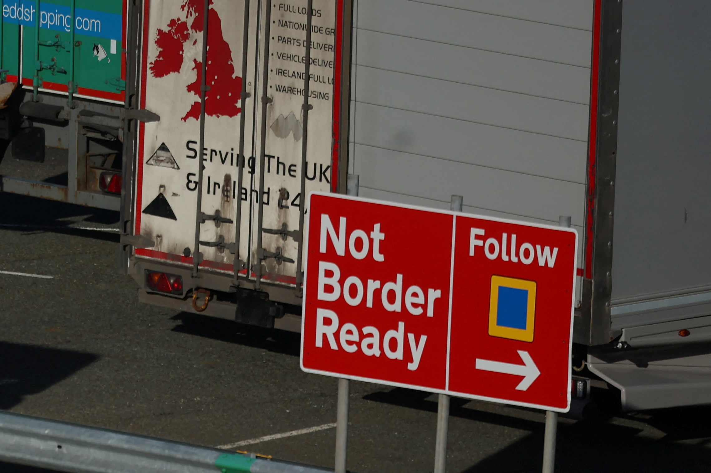 Heavy goods trailers are seen near a 'Not Border Ready' sign in a lorry park at the Port of Holyhead in Holyhead