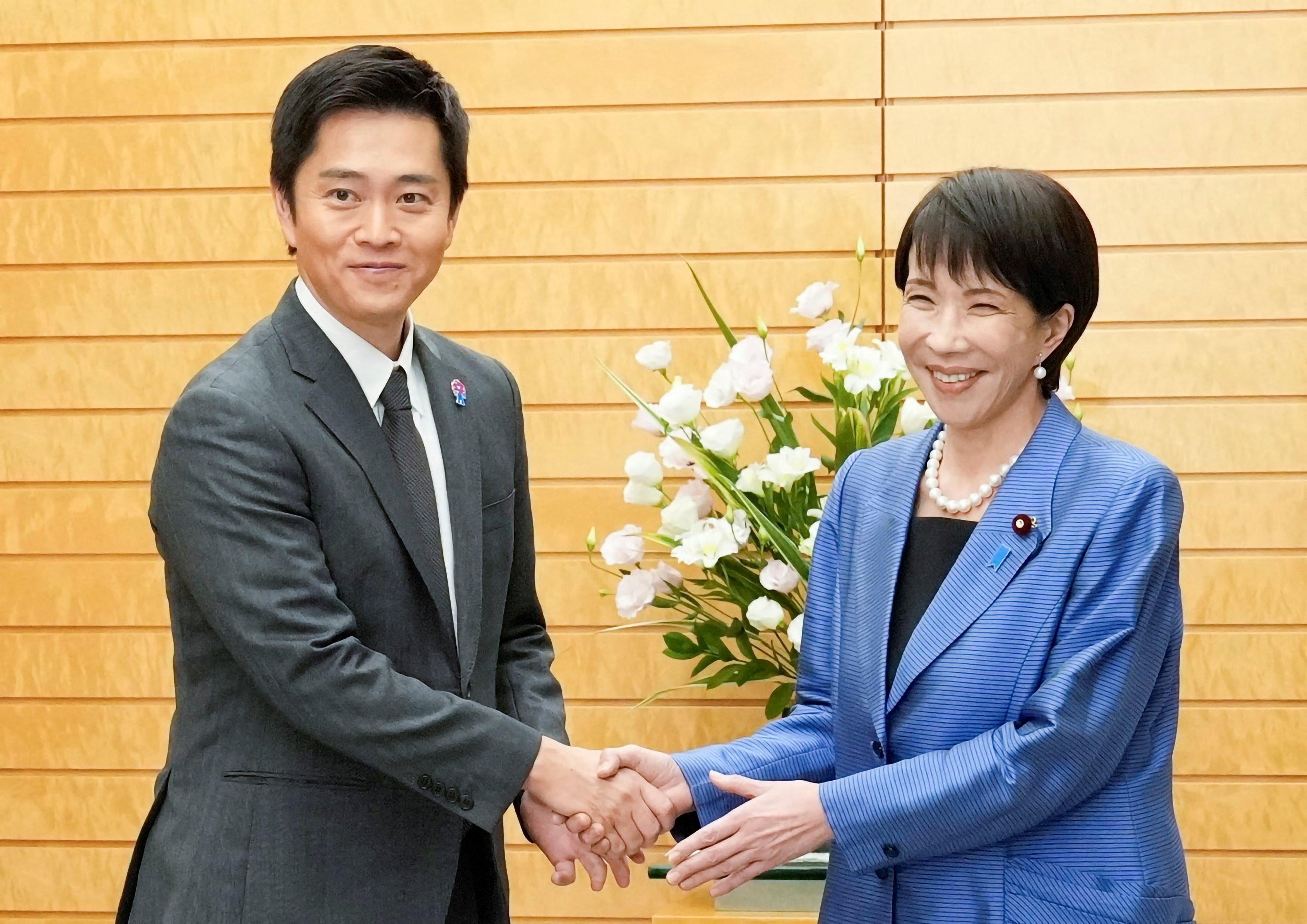 Japan's new Prime Minister Sanae Takaichi shakes hands with Hirofumi Yoshimura, leader of the Japan Innovation Party, known as Ishin, during their meeting at the prime minister's official residence in Tokyo