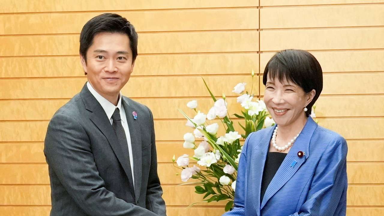 Japan's new Prime Minister Sanae Takaichi shakes hands with Hirofumi Yoshimura, leader of the Japan Innovation Party, known as Ishin, during their meeting at the prime minister's official residence in Tokyo