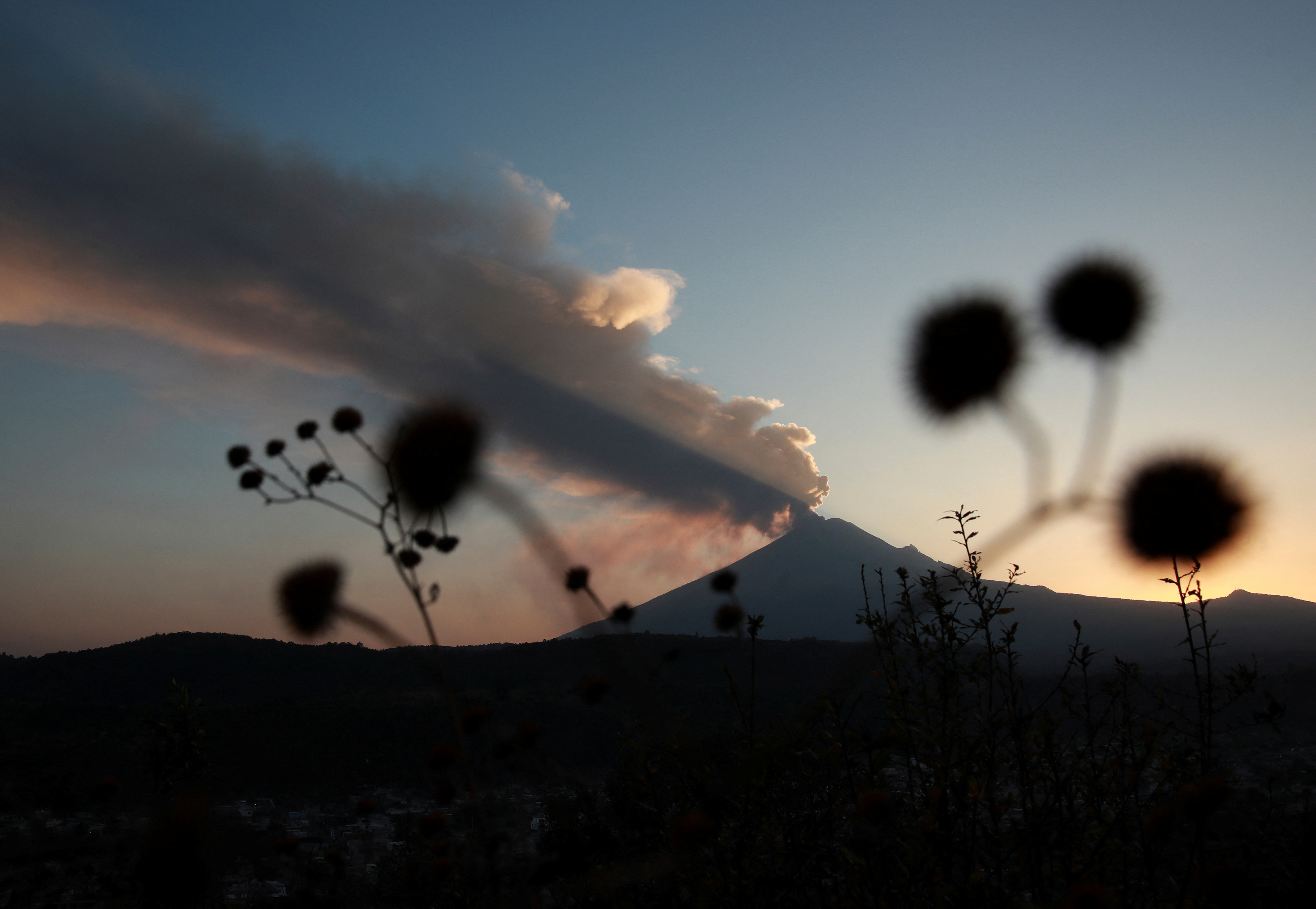 Popocatepetl volcano spews a column of ash and smoke, as seen from Santiago Xalitzintla